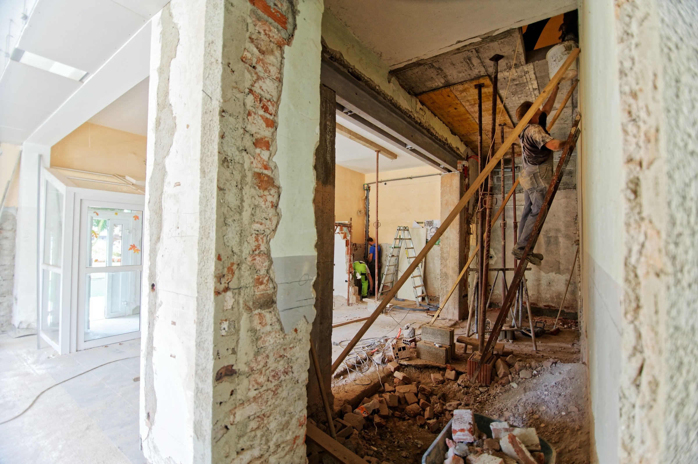 Construction workers work on renovating a building.