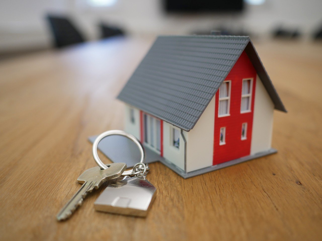 A miniature house and a key.
